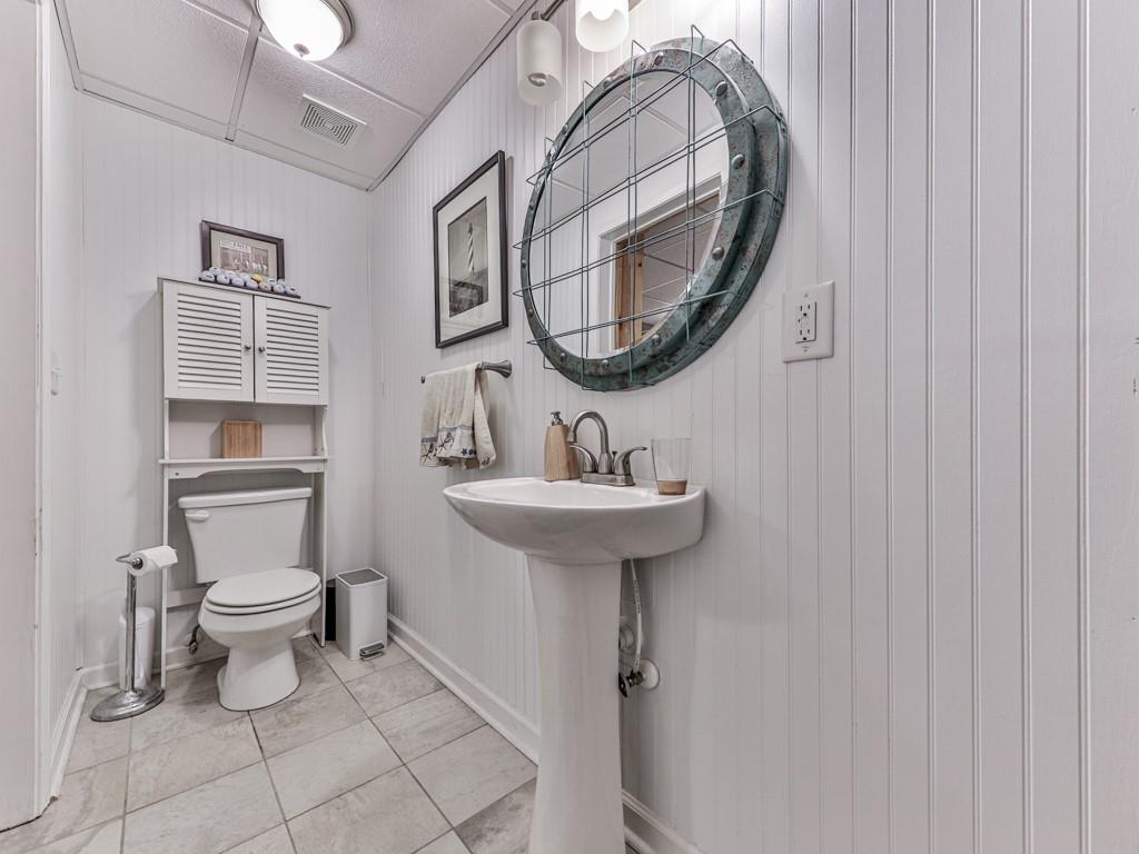 1076 Pinyan Lane Canton, GA 30115 - Photo 53 of 71 a bathroom with a toilet sink and mirror
