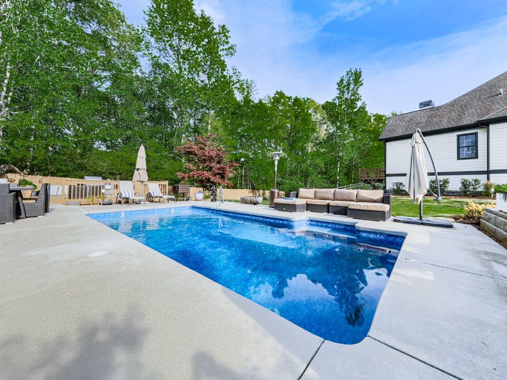 1076 Pinyan Lane Canton, GA 30115 - Photo 64 of 71 a view of a swimming pool with a patio