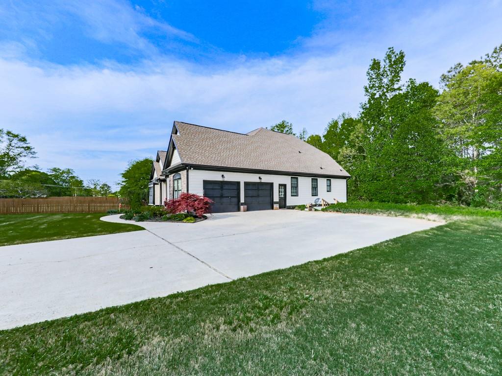 1076 Pinyan Lane Canton, GA 30115 - Photo 66 of 71 a front view of a house with a yard and garage