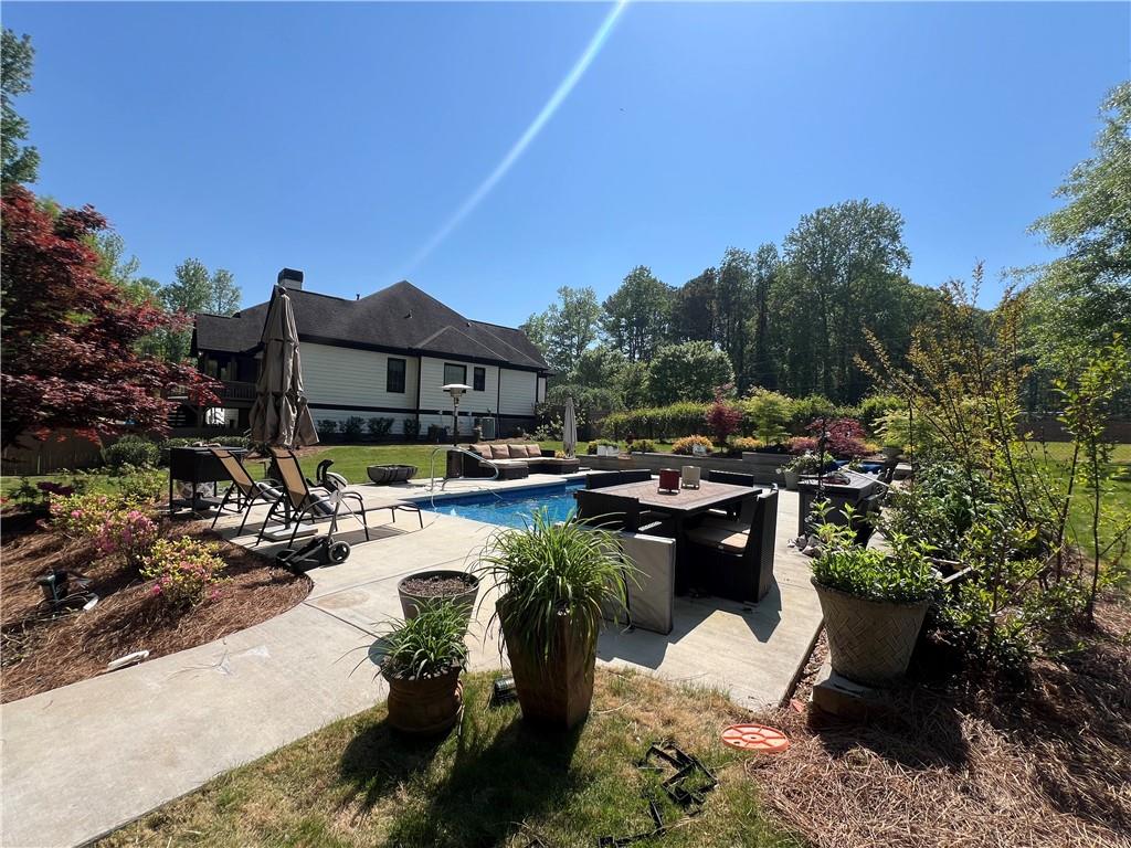 1076 Pinyan Lane Canton, GA 30115 - Photo 8 of 71 a view of swimming pool with outdoor seating and plants