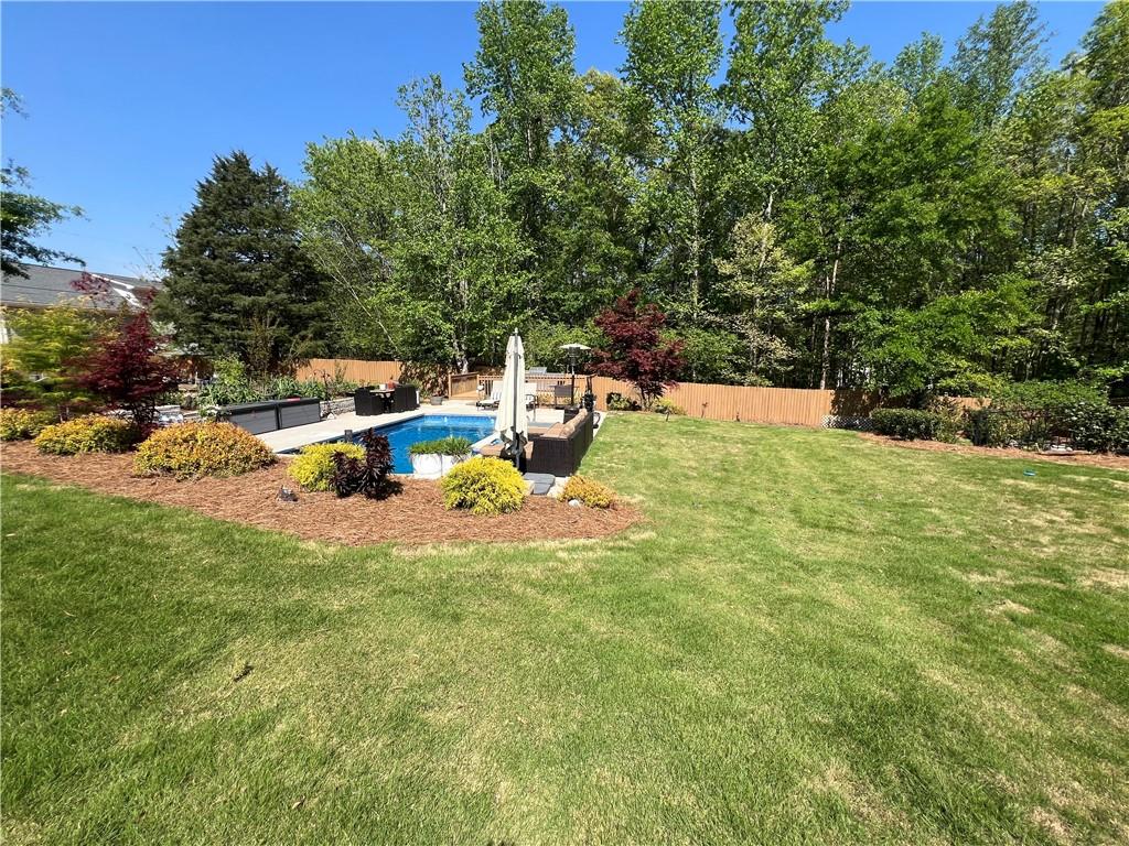1076 Pinyan Lane Canton, GA 30115 - Photo 10 of 71 a backyard of a house with table and chairs