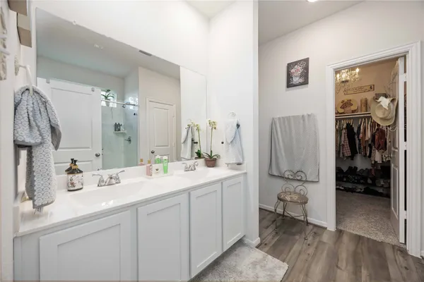 a bathroom with a glass shower door and a bathroom