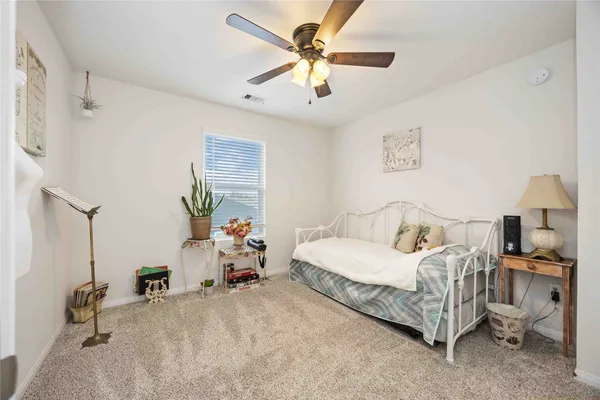 a room with furniture a air conditioner and a window