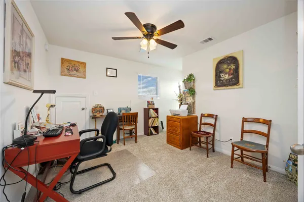 a view of a house with a yard and sitting area