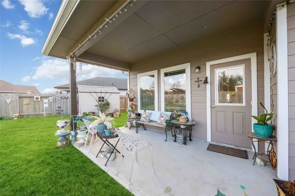 a front view of house with a garden and patio