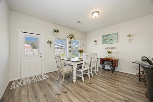 a view of a dining room with furniture and wooden floor