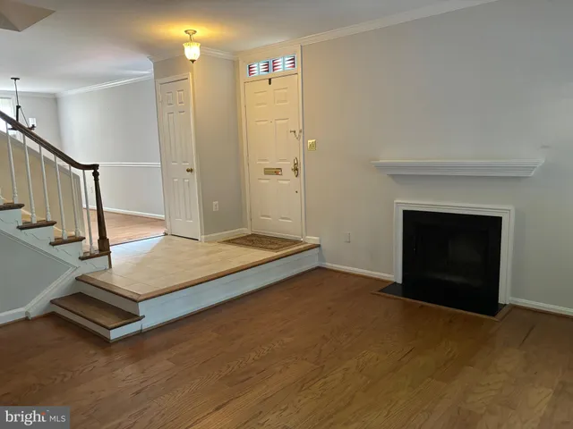 a living room with hard wood floors and a fireplace
