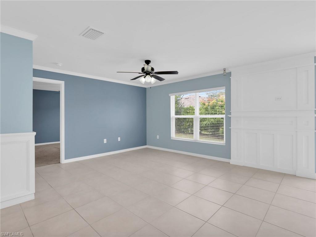 731 Hadley Place West Naples, FL 34104 - Photo 19 of 30 Dining Area With Crown Molding, Ceiling Fan, Tile Floors, Faux Window Blinds And Custom Woodwork Wall Feature