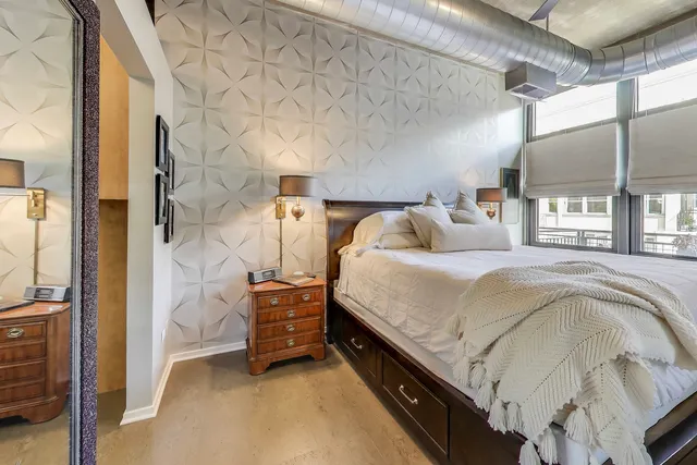 a bed room with a bed and a night stand