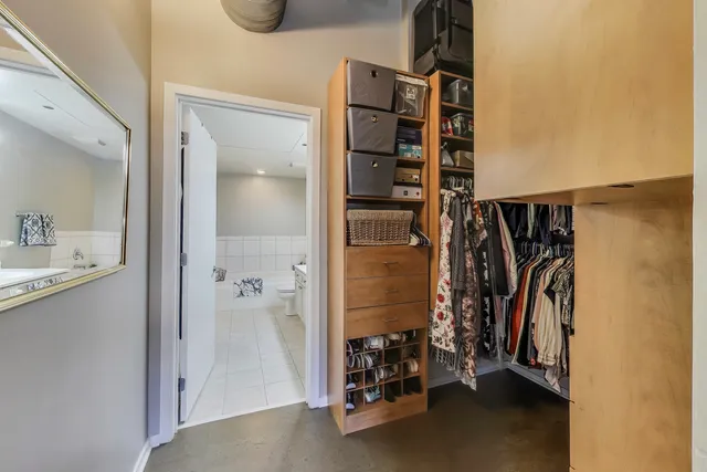 a view of walk in closet with clothes