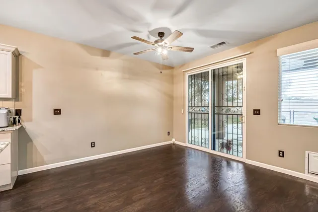 a view of a kitchen with kitchen island a sink stainless steel appliances and cabinets