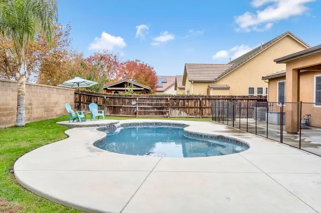 a view of an house with swimming pool and porch