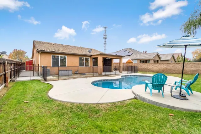 a building outdoor space with patio furniture and garden