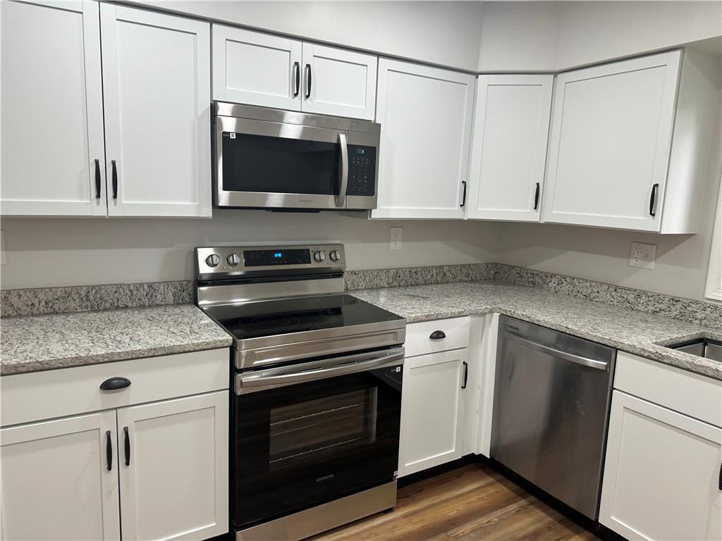 201 Clever Road McKees Rocks, PA 15136 - Photo 9 of 30 a kitchen with stainless steel appliances granite countertop a stove microwave and sink