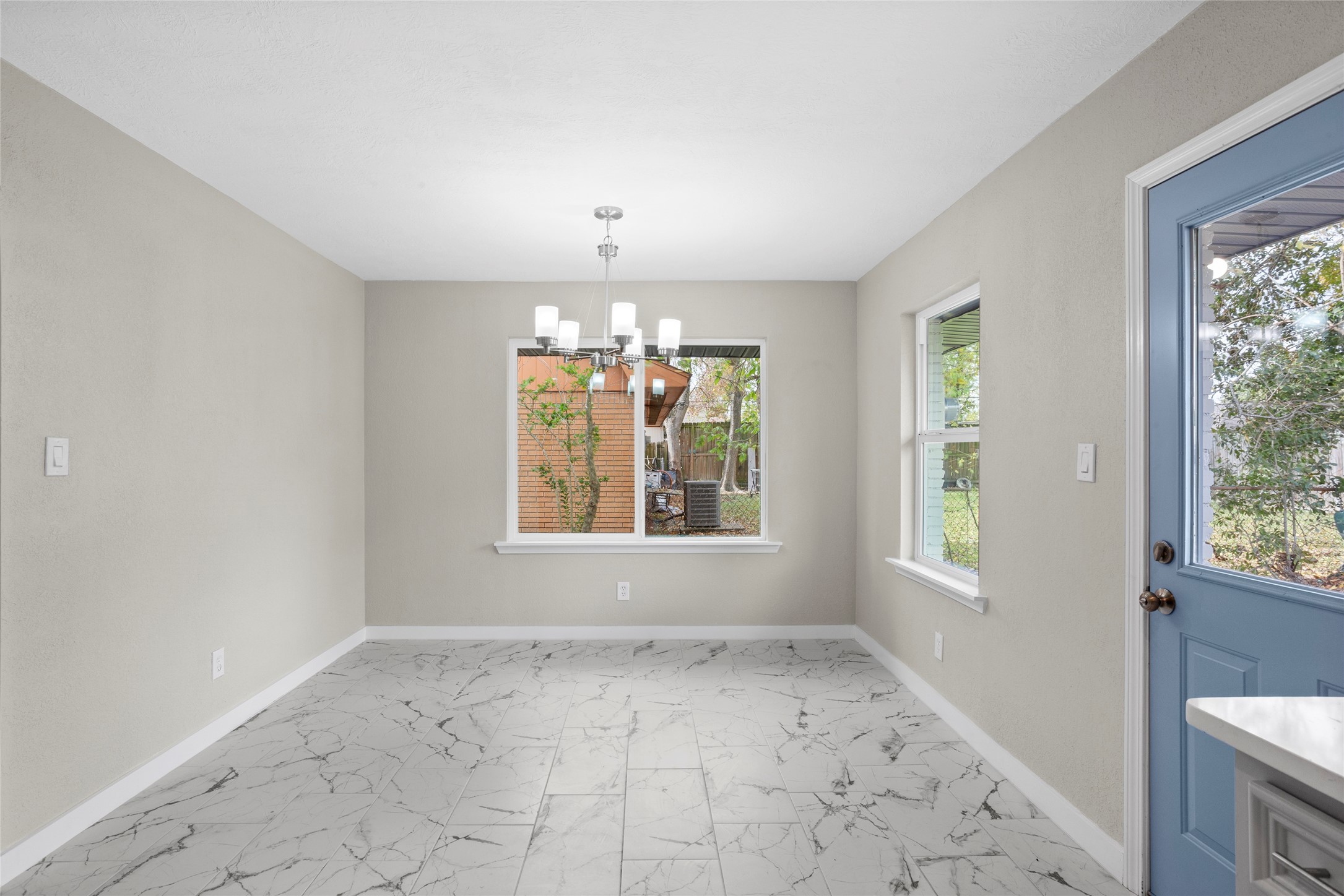 10127 Tolman Street Houston, TX 77034 - Photo 9 of 27 This dining area is an open-concept space that seamlessly blends with the kitchen, defined by a sophisticated and airy aesthetic.