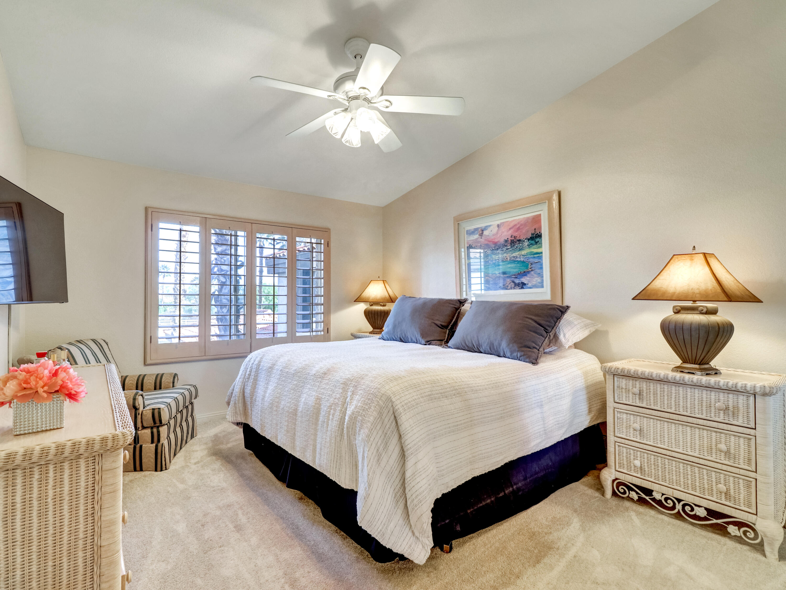 55393 Winged Foot La Quinta, CA 92253 - Photo 19 of 29 a bedroom with a bed and a chandelier