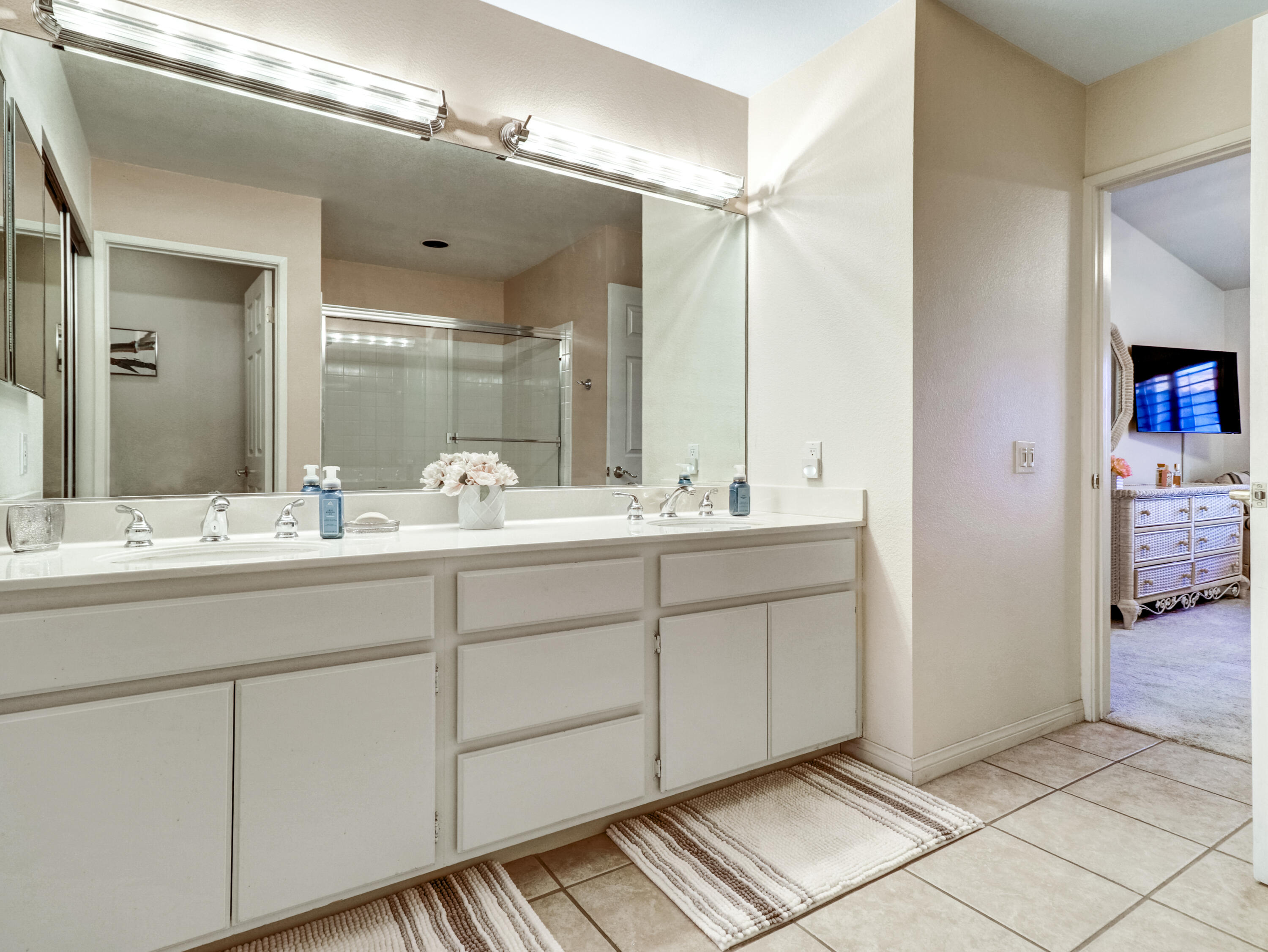 55393 Winged Foot La Quinta, CA 92253 - Photo 23 of 29 a bathroom with a double vanity sink and a mirror
