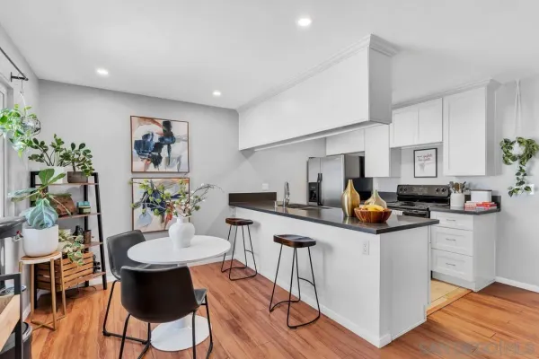 a kitchen with stainless steel appliances kitchen island granite countertop a sink and cabinets