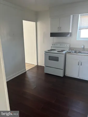 a kitchen with granite countertop a stove and a sink