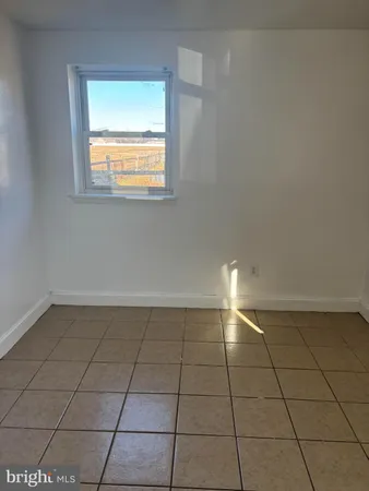 a view of a kitchen with windows and an empty room