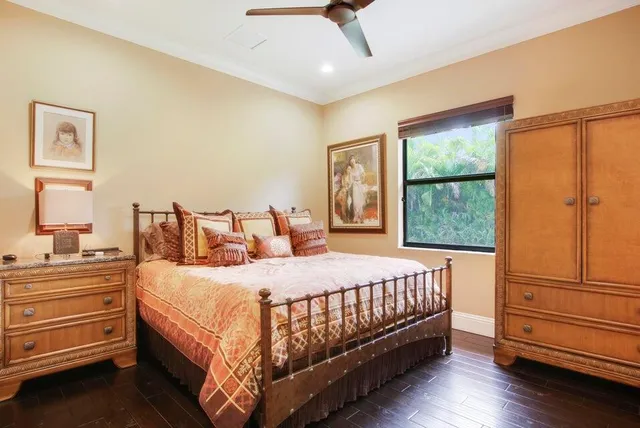 a bedroom with a bed and large window