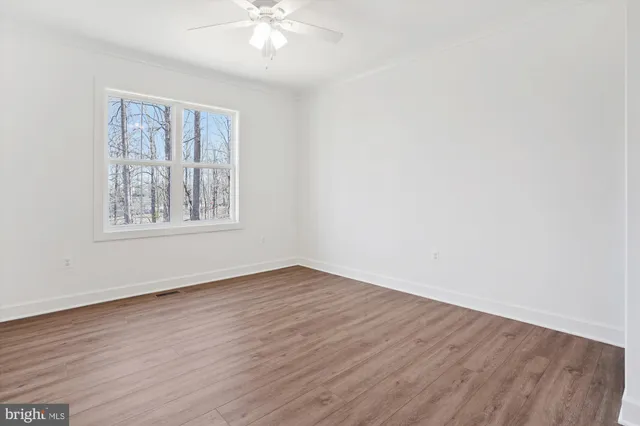a view of wooden floor and chandelier in a room