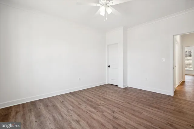 a view of an empty room with wooden floor