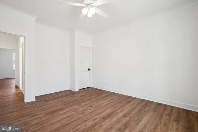 a view of a room with wooden floor