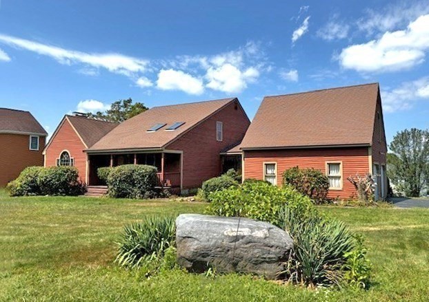 a front view of house with yard and green space