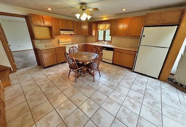 29 Highland View Drive Sutton, MA 01590 - Photo 13 of 40 a kitchen with stainless steel appliances granite countertop a refrigerator and a stove top oven