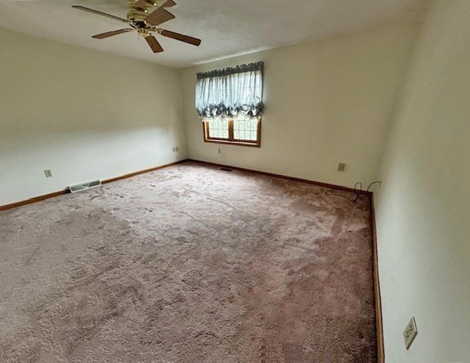 29 Highland View Drive Sutton, MA 01590 - Photo 24 of 40 an empty room with windows and fan
