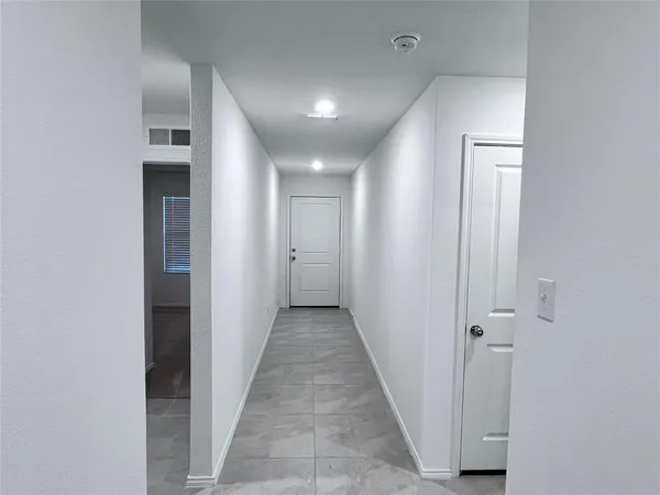 a view of a hallway with wooden floor and closet