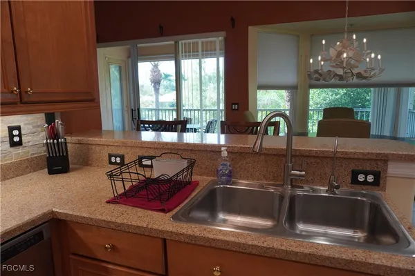 a kitchen counter with a sink and cabinets