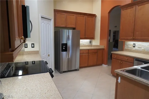a kitchen with a sink stove and refrigerator