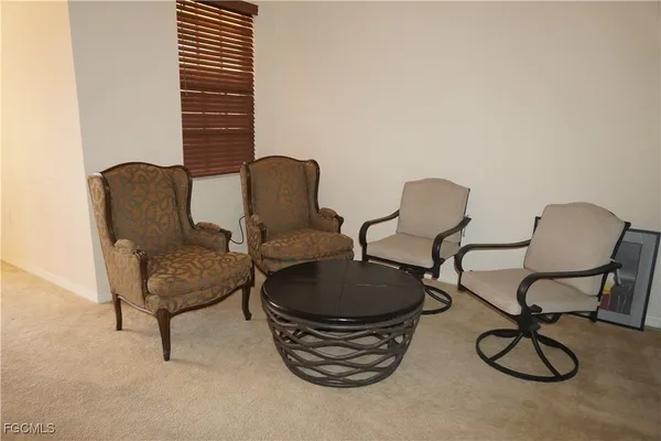 a dining room with furniture and a flat screen tv