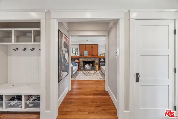 a view of a hallway with wooden floor and entryway