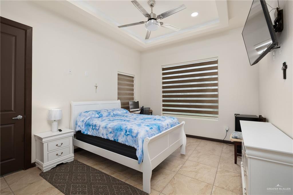 2615 South 43 Rd Lane McAllen, TX 78503 - Photo 11 of 22 a bedroom with a bed and a chandelier