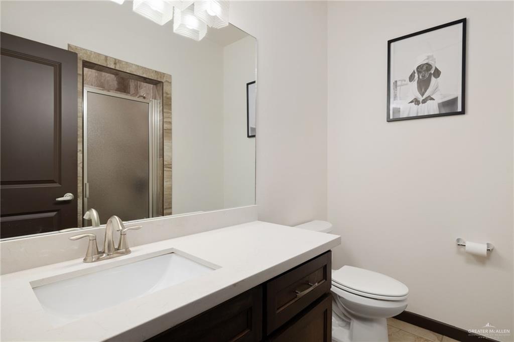 2615 South 43 Rd Lane McAllen, TX 78503 - Photo 14 of 22 a bathroom with a sink a toilet and mirror