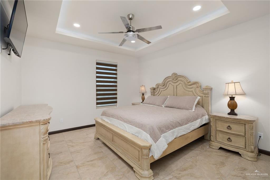 2615 South 43 Rd Lane McAllen, TX 78503 - Photo 17 of 22 a bedroom with a bed and a chandelier