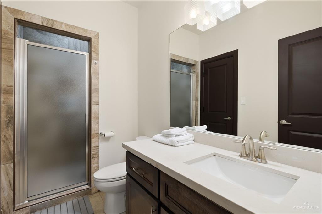 2615 South 43 Rd Lane McAllen, TX 78503 - Photo 18 of 22 a bathroom with a sink a toilet and shower