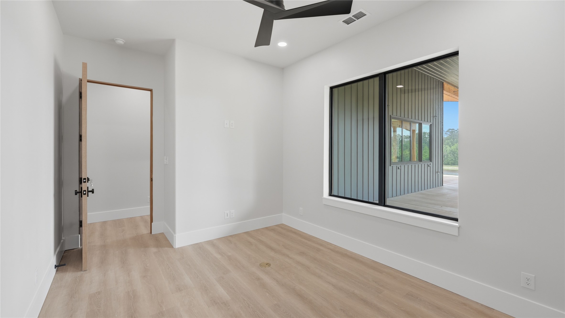 447 County Road 2211 Rusk, TX 75785 - Photo 45 of 50 an empty room with wooden floor and a bathroom view