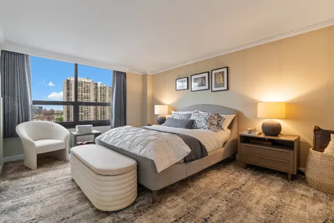 a spacious bedroom with a bed and a large window