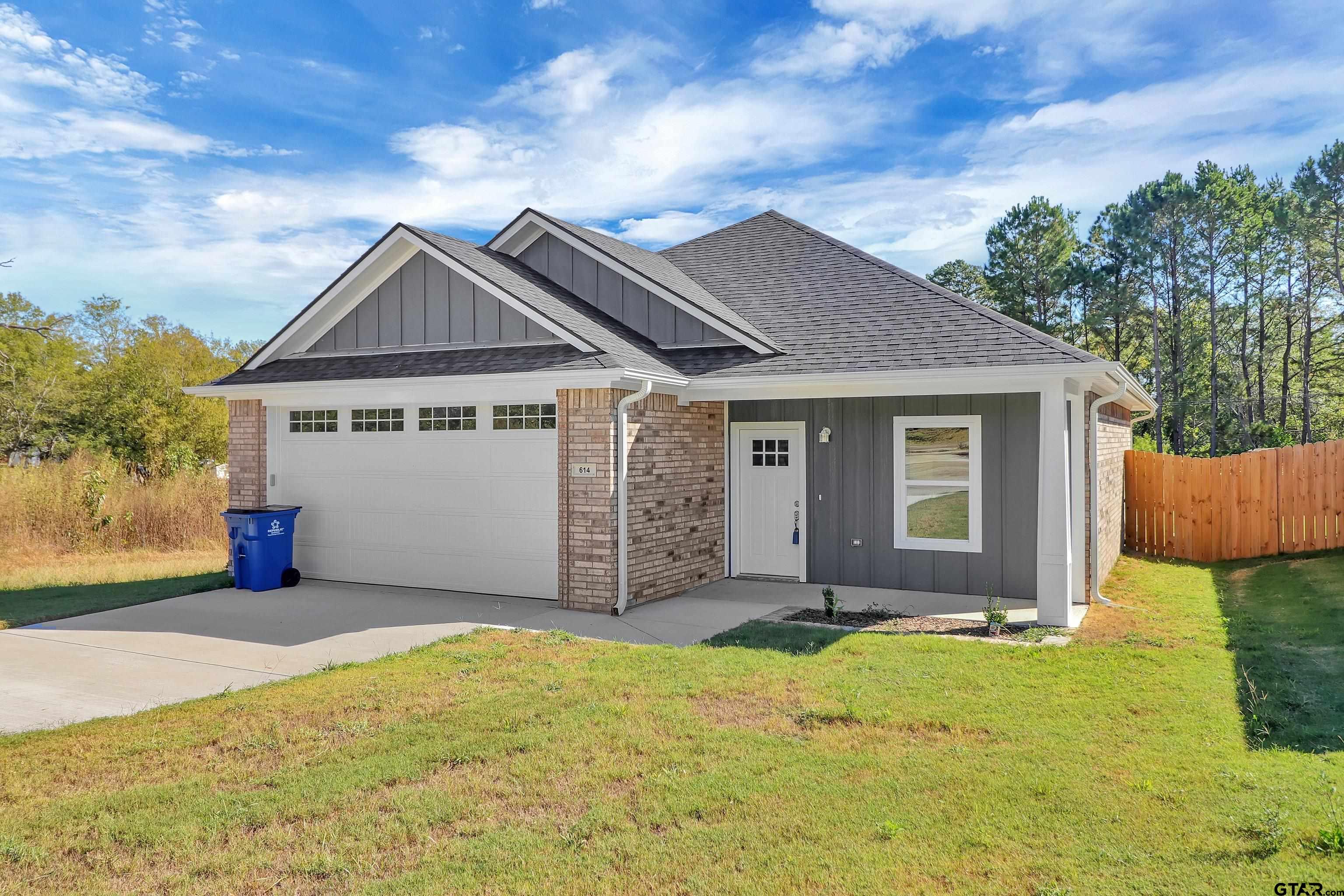 614 North Commerce Street Overton, TX 75684 - Photo 1 of 24 a front view of a house with a yard