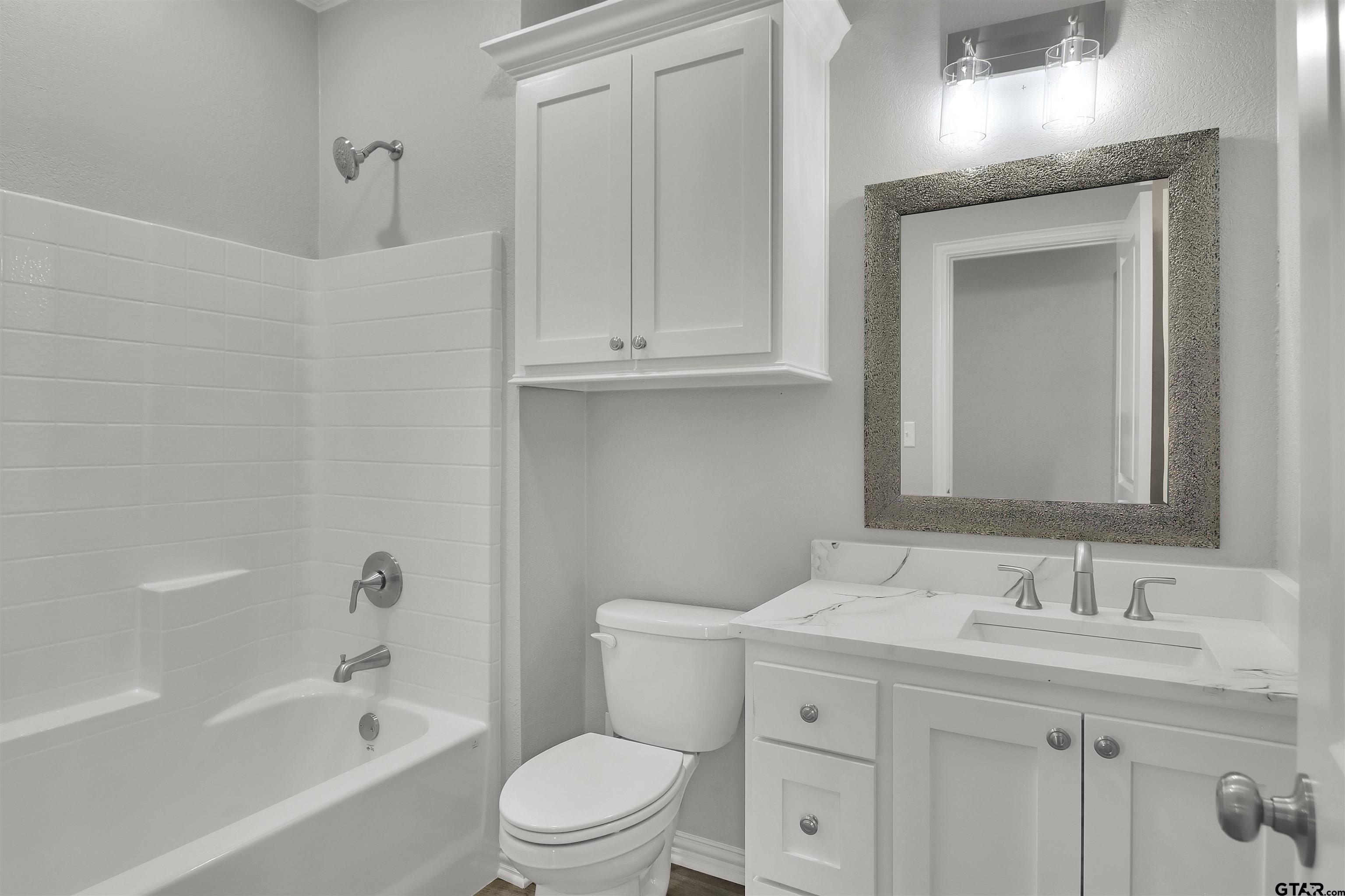 614 North Commerce Street Overton, TX 75684 - Photo 16 of 24 a bathroom with a sink a toilet and shower