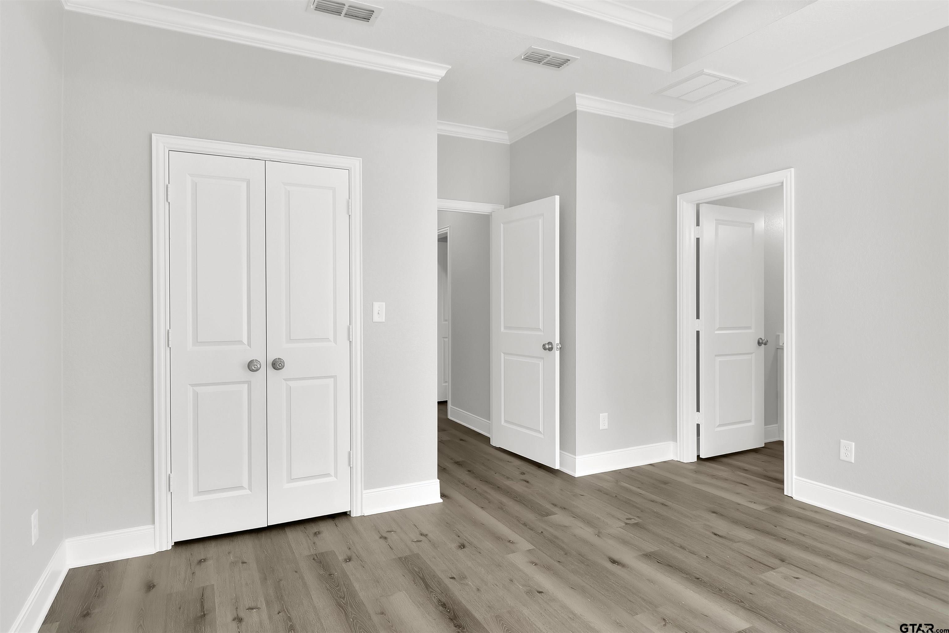 614 North Commerce Street Overton, TX 75684 - Photo 19 of 24 an empty room with wooden floor & closet area