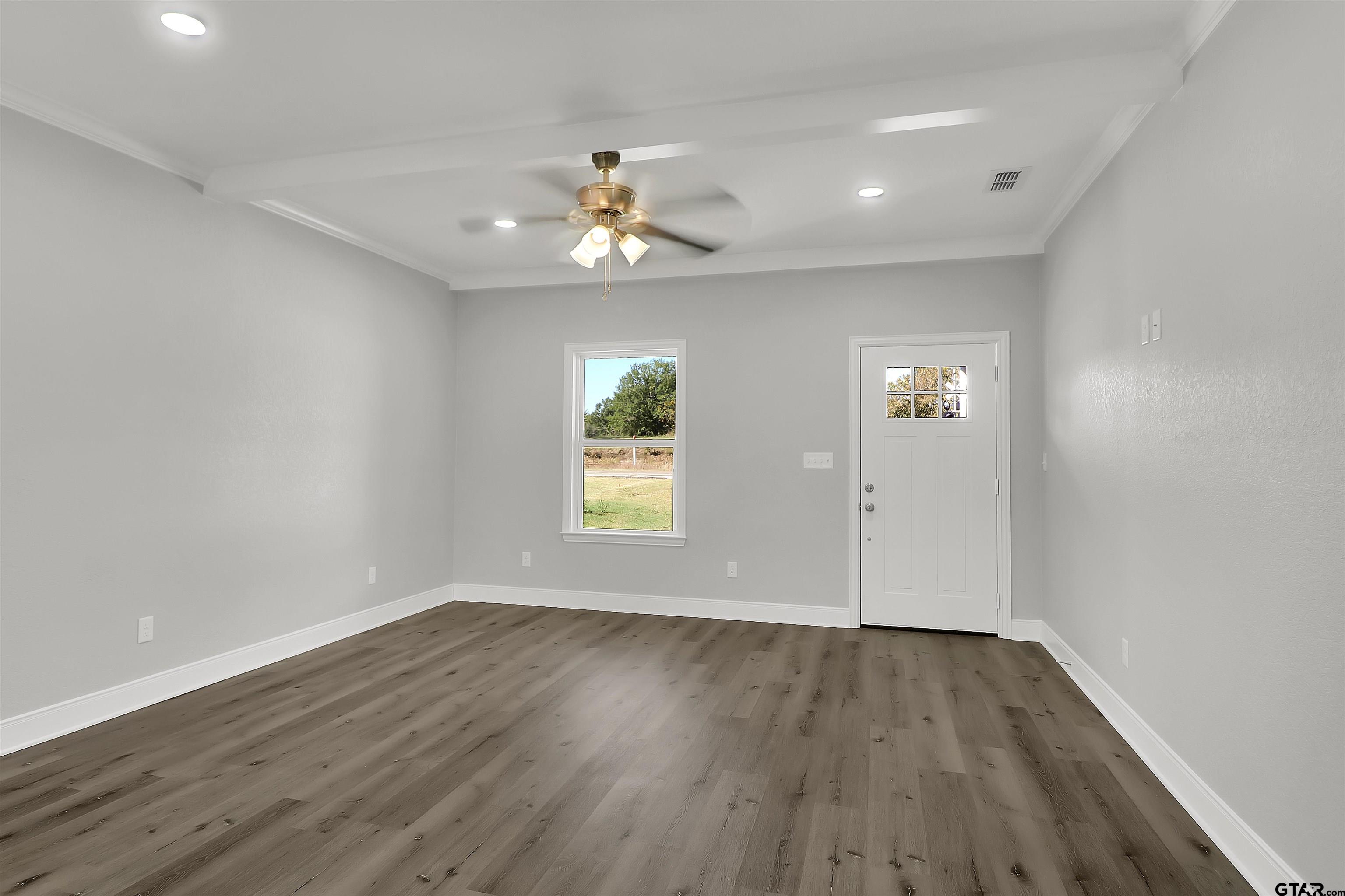 614 North Commerce Street Overton, TX 75684 - Photo 2 of 24 wooden floor in an empty room with a window
