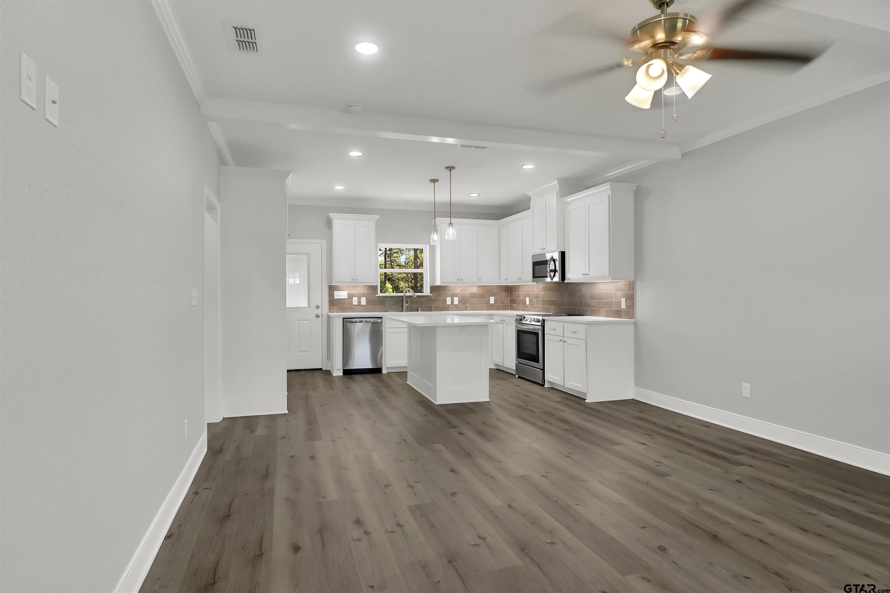 614 North Commerce Street Overton, TX 75684 - Photo 3 of 24 a view of kitchen with wooden floor