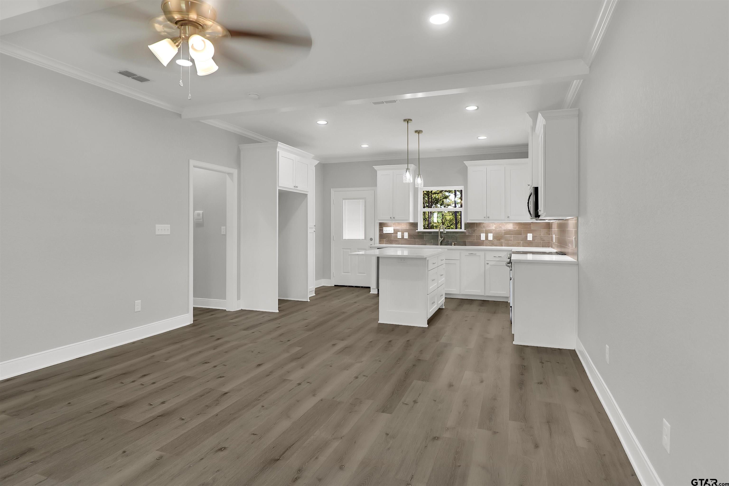 614 North Commerce Street Overton, TX 75684 - Photo 4 of 24 a view of a kitchen with a sink cabinets and wooden floor