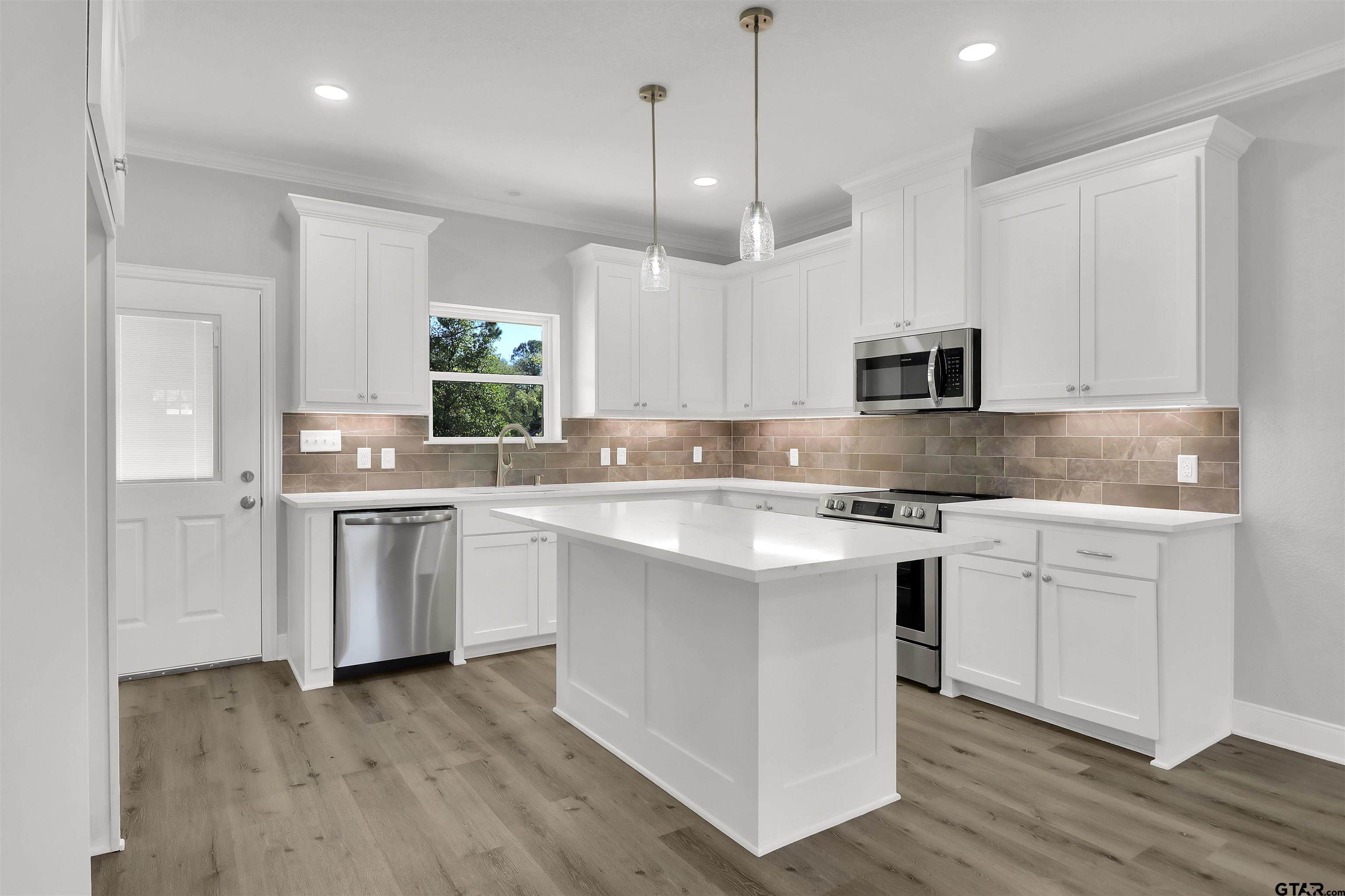 614 North Commerce Street Overton, TX 75684 - Photo 7 of 24 a kitchen with white cabinets appliances and sink