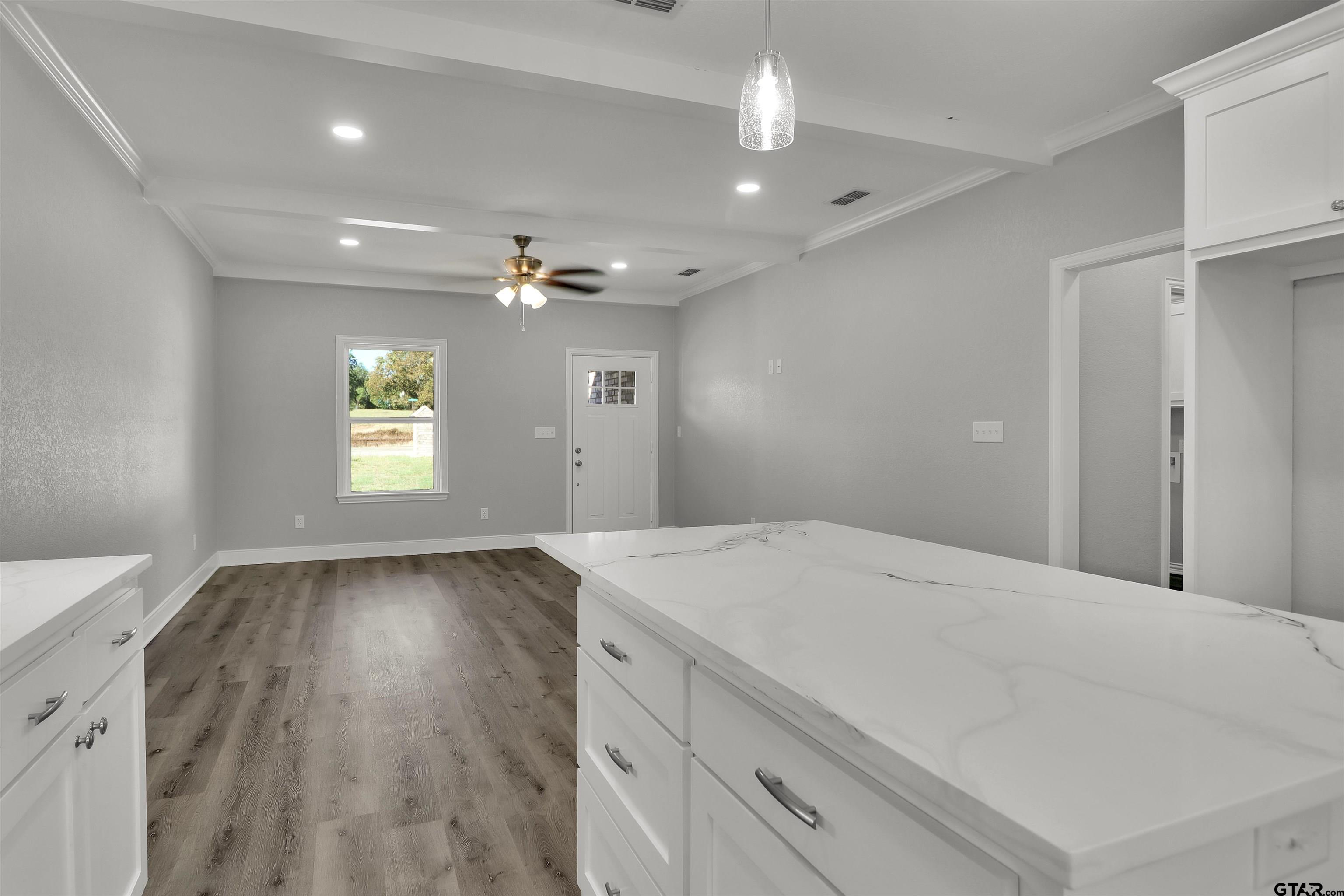 614 North Commerce Street Overton, TX 75684 - Photo 10 of 24 a view of an empty room and window and wooden floor
